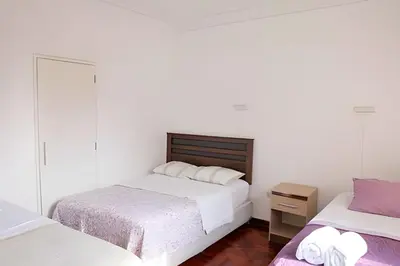a bedroom with two beds and a mirror at Casa en el corazón de Miraflores in Lima