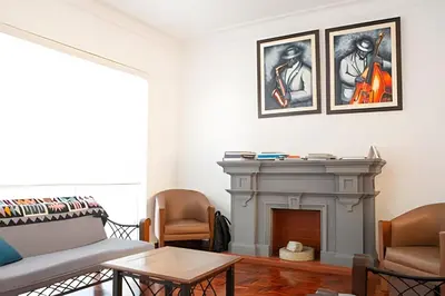 a living room with a couch and a fireplace at Casa en el corazón de Miraflores in Lima