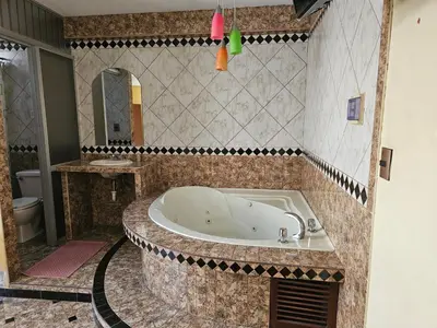 a bath tub in a bathroom with a sink at Hotel Atenas in Lima