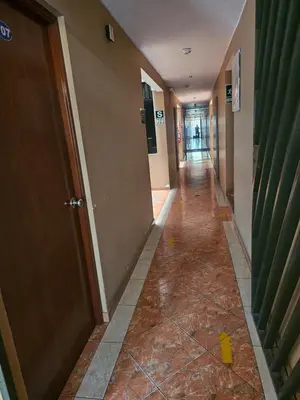 a hallway in a building with a long corridor at Hotel Atenas in Lima
