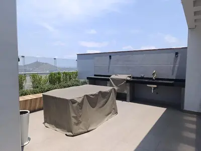 a covered table on a balcony with a view of the ocean at Tu mejor opción Departamento Familiar in Lima