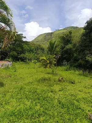 a field of green grass with mountains in the background at Bella Victoria Ecolodge in Santa María