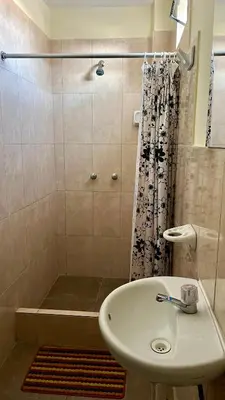 a bathroom with a sink and a shower at Paracas Ayni in Paracas