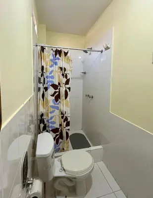 a bathroom with a toilet and a shower at Paracas Ayni in Paracas