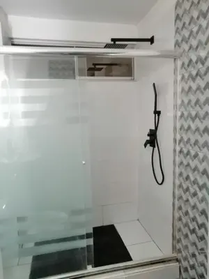 a room with a shower with a phone on the wall at Loft and reception RISHEL in Chincha