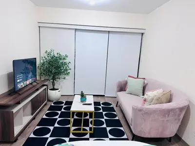 a living room with a couch and a tv at Monterrico Polo Aparts #22- Dpto 2 Dorm 2 baños - Frente Embajada USA in Lima