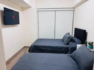a living room with two beds and a couch at Monterrico Polo Aparts #22- Dpto 2 Dorm 2 baños - Frente Embajada USA in Lima