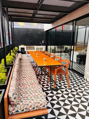a cafeteria with a table and chairs on a checkered floor at Monterrico Polo Aparts #22- Dpto 2 Dorm 2 baños - Frente Embajada USA in Lima