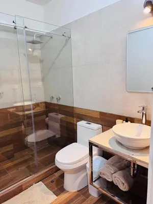 a bathroom with a toilet and a sink and a shower at Monterrico Polo Aparts #22- Dpto 2 Dorm 2 baños - Frente Embajada USA in Lima