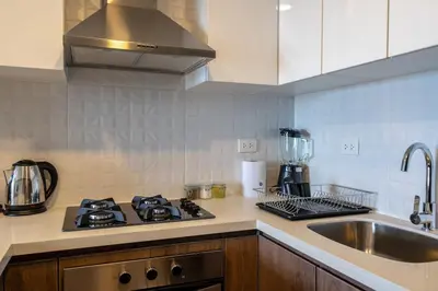 a kitchen with a stove top oven next to a sink at Bagheera 2BR by Geko in Lima