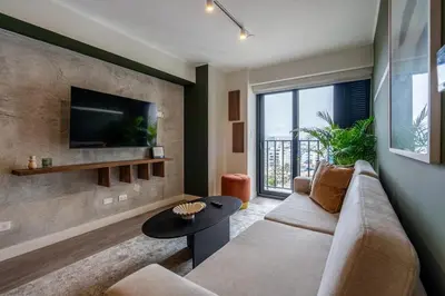 a living room with a couch and a tv at Bagheera 2BR by Geko in Lima