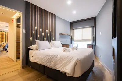a bedroom with a large bed and a television at The Rooftop 2BR by Geko in Lima