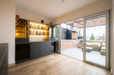 a kitchen with a bar and a living room at The Rooftop 2BR by Geko in Lima