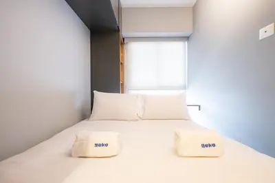 a bedroom with a bed with two pillows on it at The Rooftop 2BR by Geko in Lima