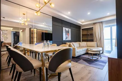 a dining room and living room with a table and chairs at The Rooftop 2BR by Geko in Lima