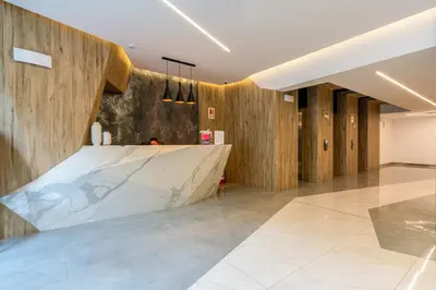 a lobby with a marble counter and wooden walls at Miraflores Modern Apartments Benavides by Geko in Lima