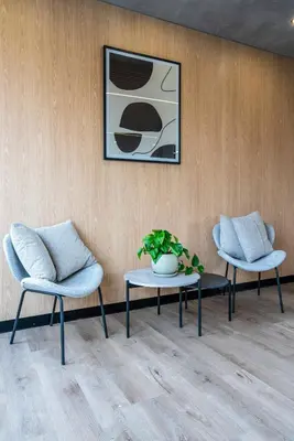 two chairs and a table and a picture on a wall at Miraflores Modern Apartments Benavides by Geko in Lima
