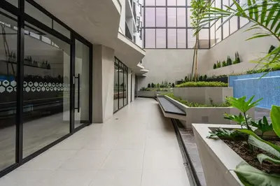 a hallway of a building with potted plants at Miraflores Modern Apartments Benavides by Geko in Lima