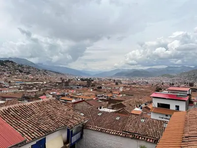 a view of a city with roofs and mountains at Auquis Hostel in Cusco