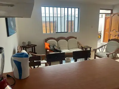 a living room with a couch and a table at Punta Hermosa - depa Santa Cruz in Punta Hermosa