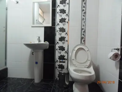 a bathroom with a toilet and a sink at B&B Cusing Wasi in Lima