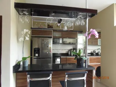a kitchen with a black counter and some appliances at B&B Cusing Wasi in Lima