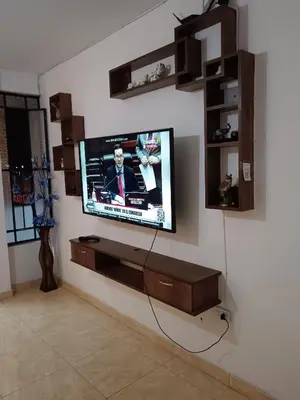 a flat screen tv on a wall in a living room at Departamento Vista al Parque Coopip in Lima