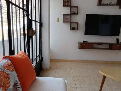 a living room with a flat screen tv on a wall at Departamento Vista al Parque Coopip in Lima