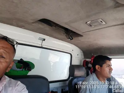 two men sitting in the back of a bus at Santa Rosa 2 in Lima