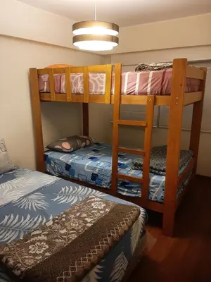 a bedroom with two bunk beds and a bed at 4 habitaciones in Lima