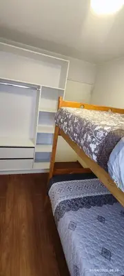 a bedroom with two bunk beds and a closet at 4 habitaciones in Lima