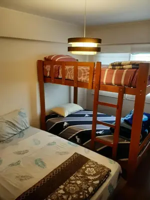 a room with two bunk beds and a bed at 4 habitaciones in Lima