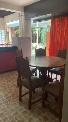 a dining room table with chairs and a table and a table and chairs at Residencial Misky Dreams in Huánuco