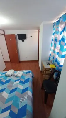 a bedroom with a bed and a chair and a desk at Habitación Privada con Entrada Independiente in Ica