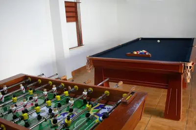 a group of toy figures sitting on top of a pool table at Kampu Wasi - Casa de Campo in Pachacamac