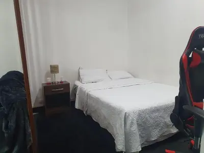 a small bedroom with a bed and a mirror at Beautiful private office in Miraflores in Lima
