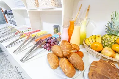a buffet filled with bread and fruit and drinks at Hostal Cusco Guest Home in Cusco