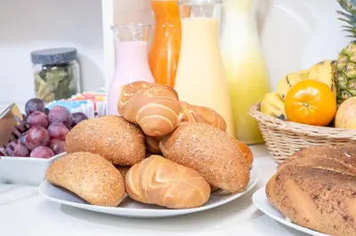 a plate of pastries and bread on a table at Hostal Cusco Guest Home in Cusco