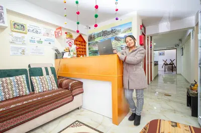 a woman standing at a counter in a store at Hostal Cusco Guest Home in Cusco