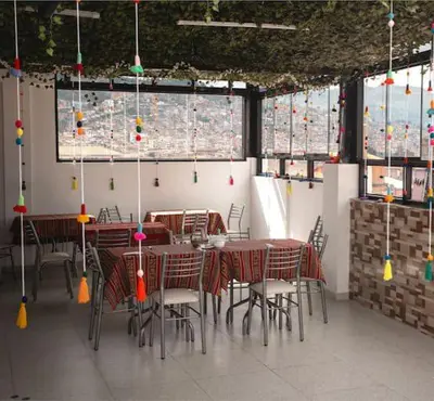 a dining room with tables and chairs and windows at Wayna Boutique Hotel in Cusco