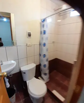 a bathroom with a toilet and a sink and a shower at Hospedaje M&M in Cusco