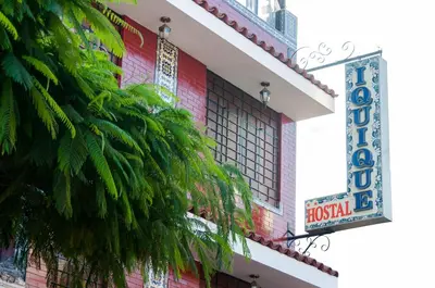 a hotel with a sign on the side of a building at Hostal Iquique in Lima