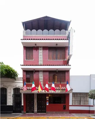 a red building with american flags on it at Hostal Iquique in Lima