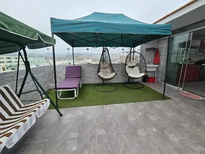 a patio with two swings and a tent at Departamento en Playa San Bartolo Con terraza in San Bartolo