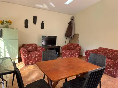 a living room with a table and chairs and a tv at Country house cieneguilla in Cieneguilla