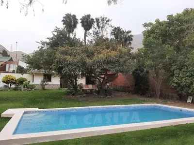 a swimming pool in the yard of a house at Country house cieneguilla in Cieneguilla
