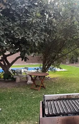 a picnic table and a bench in a park at Country house cieneguilla in Cieneguilla