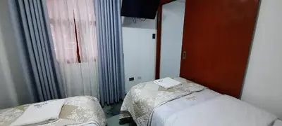 a small room with two beds and a window at La Rinconada de Churin in Churín