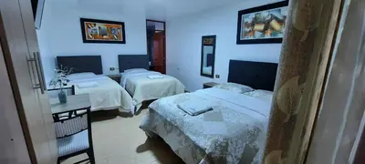 a hotel room with two beds and a mirror at La Rinconada de Churin in Churín
