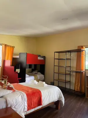 a bedroom with two beds with orange and white at Ecoterra Inka Lodge in Quillabamba